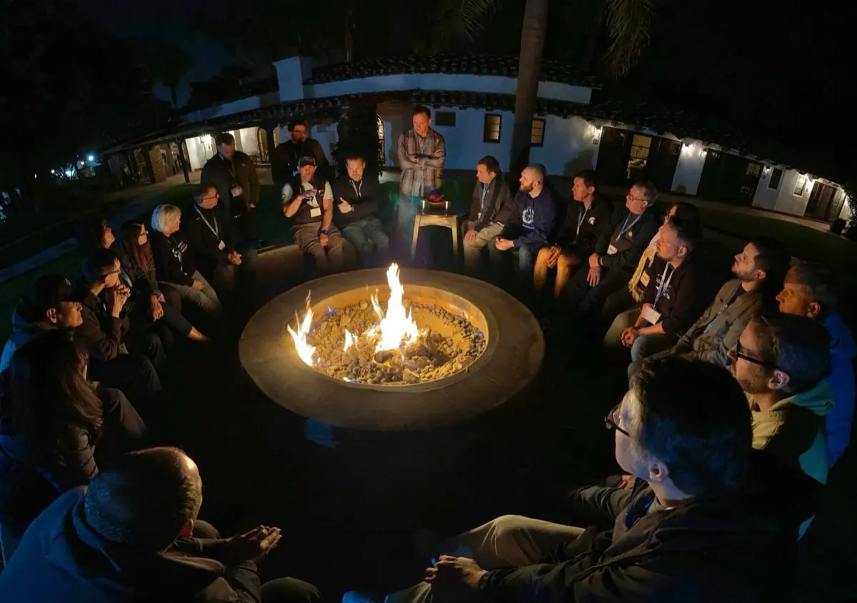 Church leaders gathered around a campfire for discussion