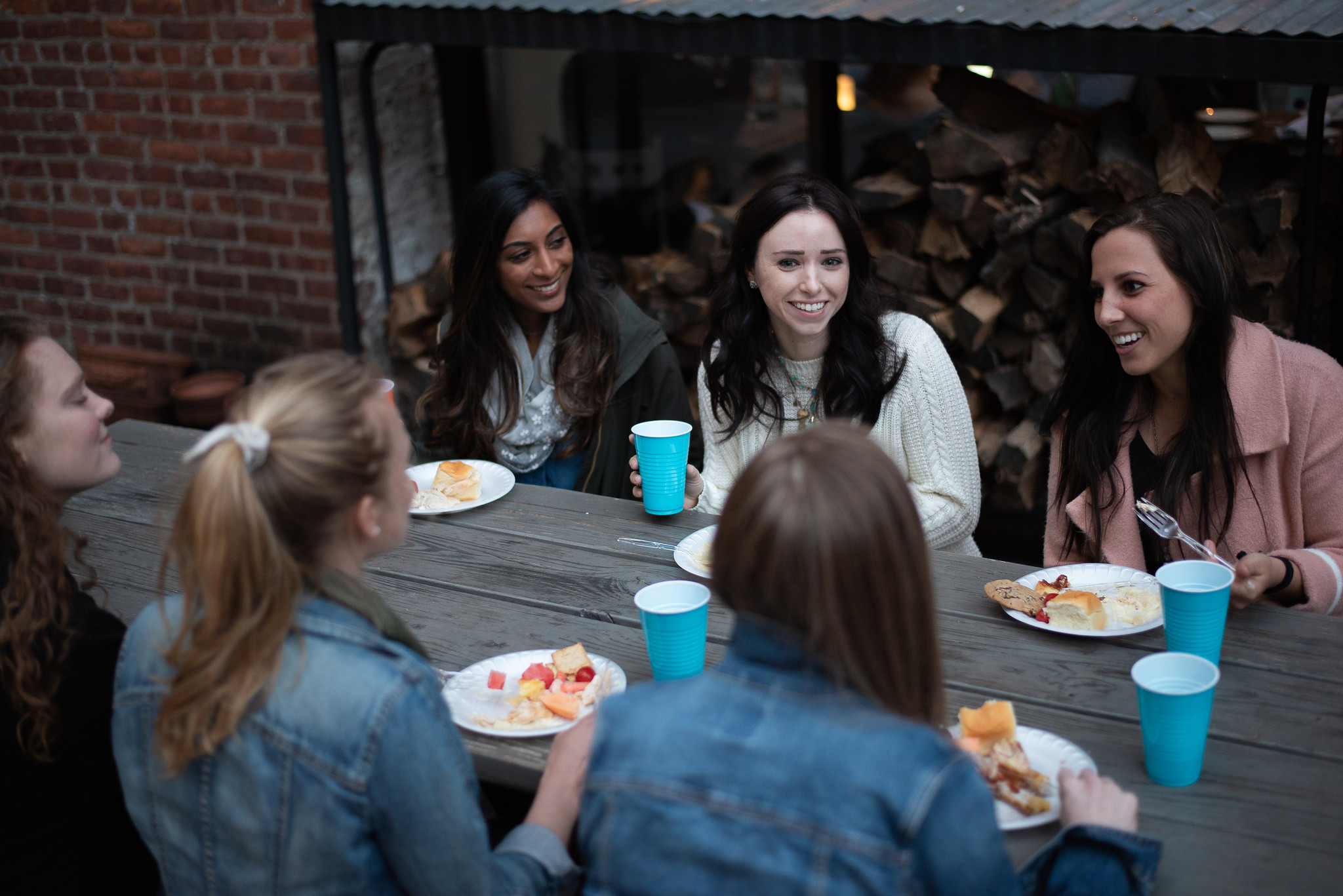 Group of women enjoying an outdoor dinner and conversation as part of a Small Group.