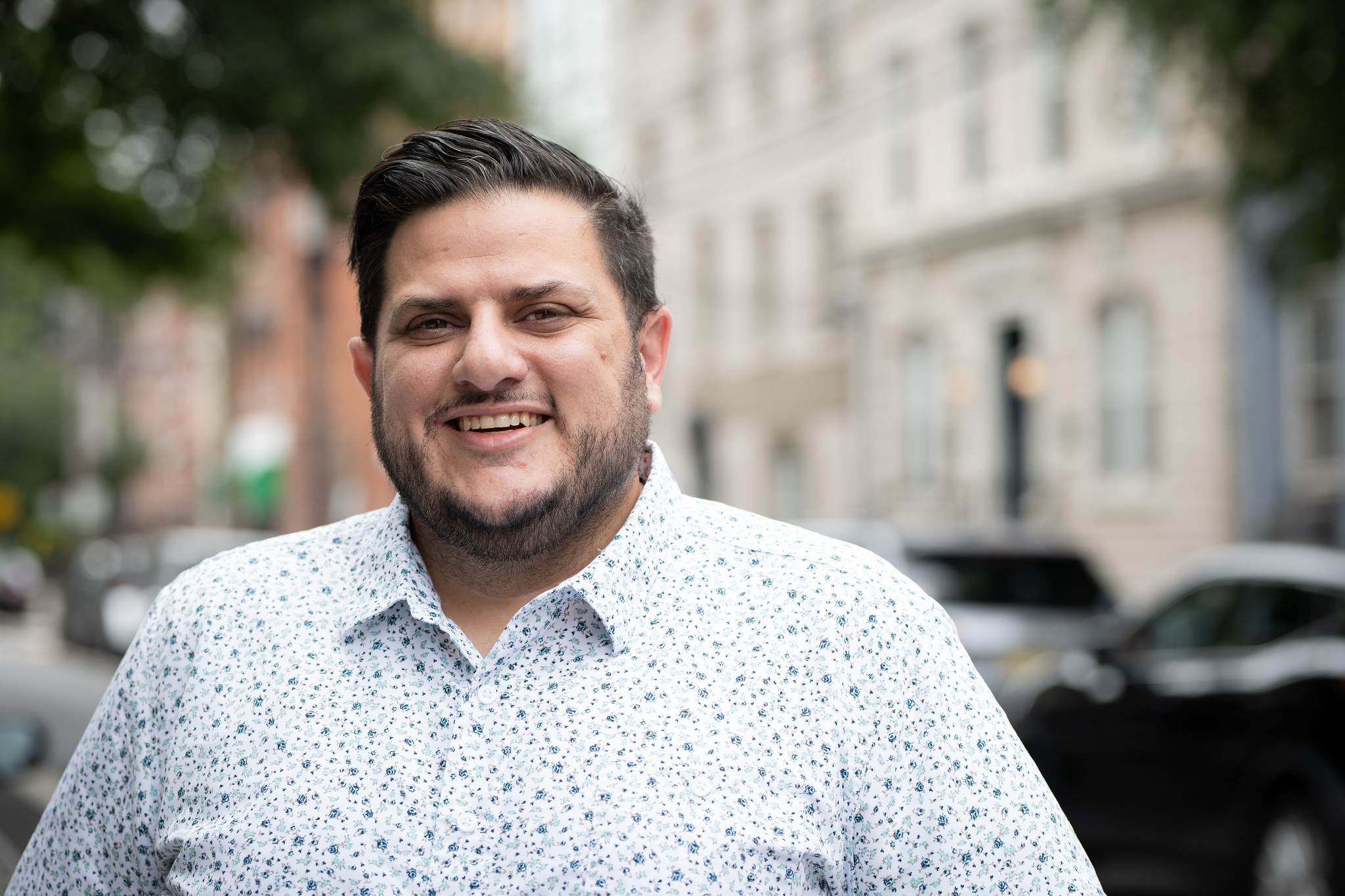 Nick Lenzi, small group leadership coach, smiling outdoors in a professional headshot.